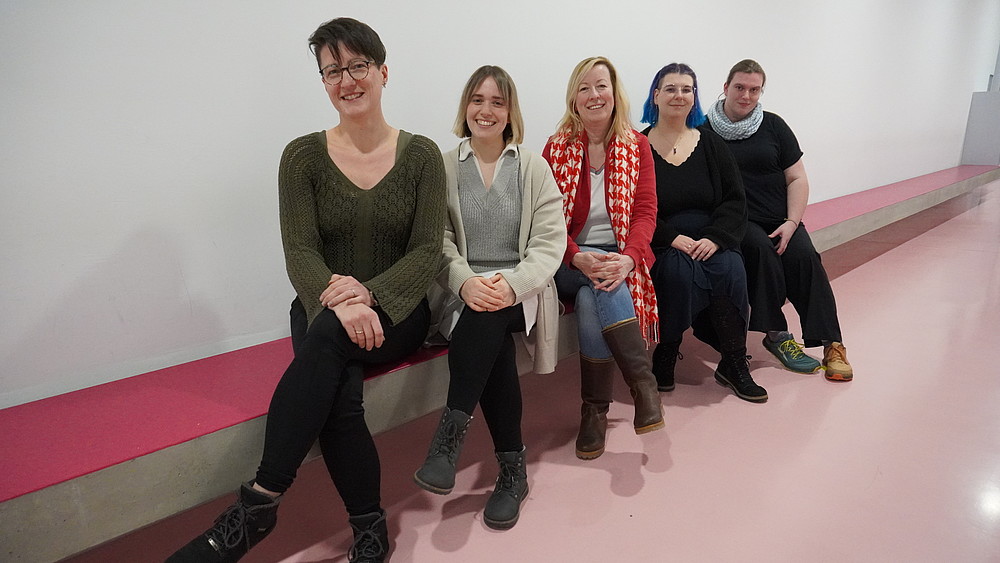 The Study Success project staff and the Vice Rector sit in a row on a bench.