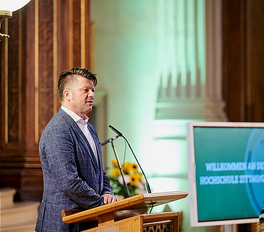 Thomas Zenker stands at the lectern.