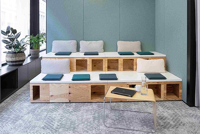 Example of a modern learning space: wooden benches with seat cushions and table