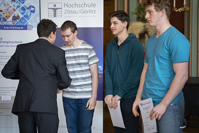 A man in a suit presents certificates to three young men