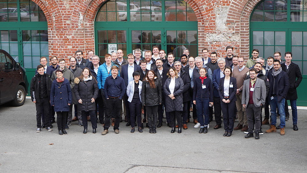 Group photo of polymer conference participants in front of the Mandau-Höfe building.