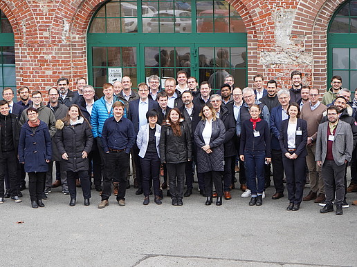 Group photo of polymer conference participants in front of the Mandau-Höfe building.