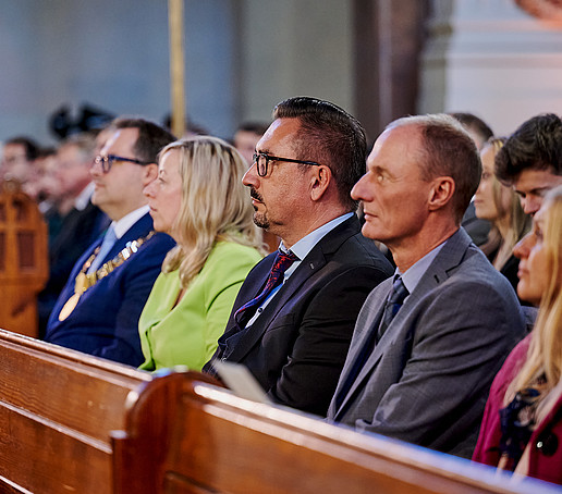 Guests in the rows of seats follow the program.