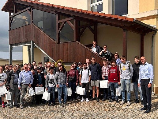 Group photo in front of the MBN company building with participants of the excursion