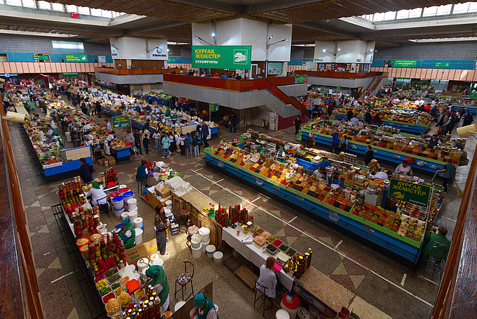A view from above of a market hall filled with stalls.