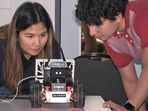 A Thai student demonstrates the autonomous functions of a model vehicle.