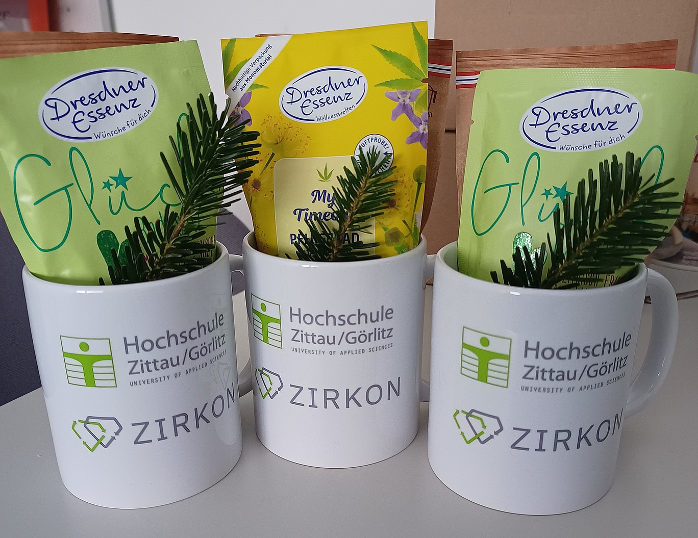 3 mugs with the logos of Zittau Görlitz University of Applied Sciences and ZIRKON