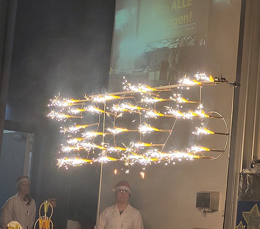 A firework in the shape of a 2025 burns down from a safe device on the stage.