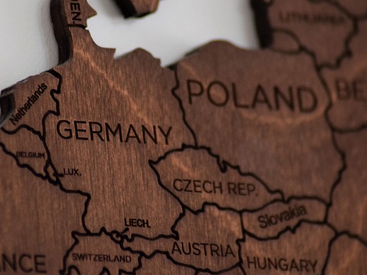 A wooden map of Europe on which you can clearly see the countries of Germany, Poland and the Czech Republic.
