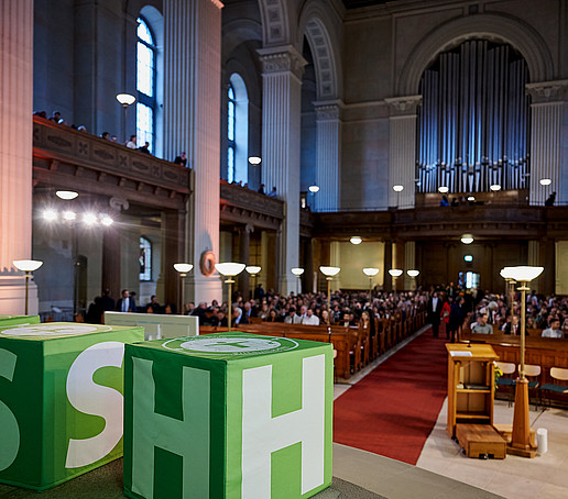 View from the altar to full rows of seats in the church.