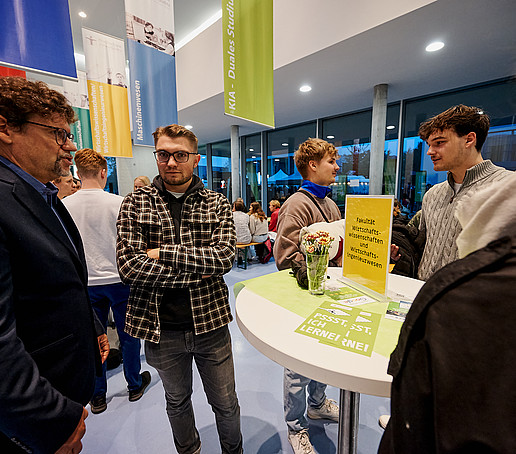 Students at the information table talk to Prof. Zips.