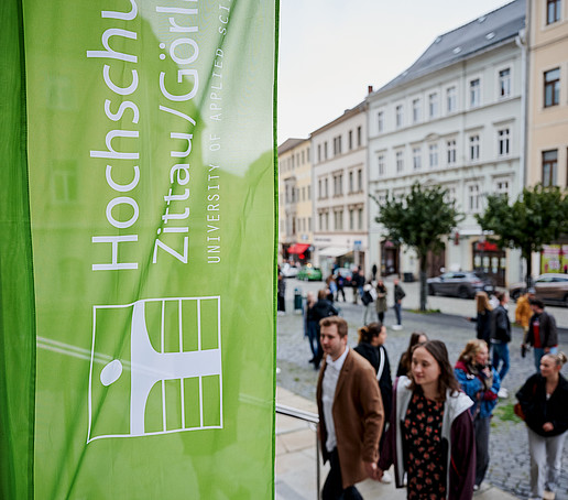 HSZG flag in front of St. John's Church, guests walk up the steps.