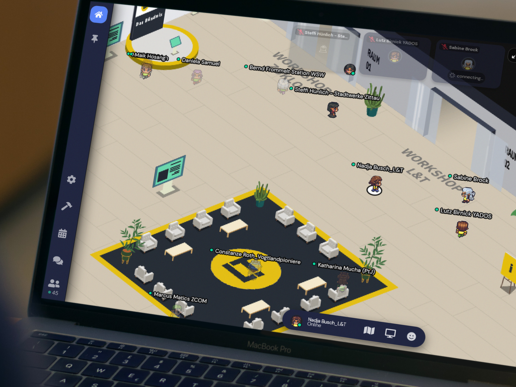 A Macbook shows a virtual world with a large corridor from which rooms lead off.