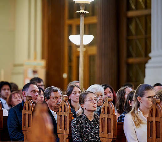 Guests in the rows of seats follow the program.