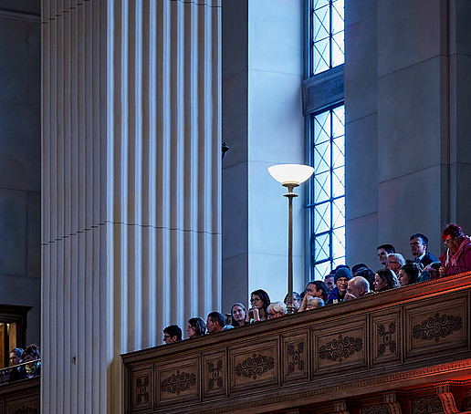 Guests in the gallery follow the program.