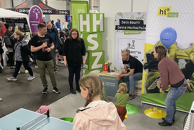 Children play mini table tennis at the HSZG stand.