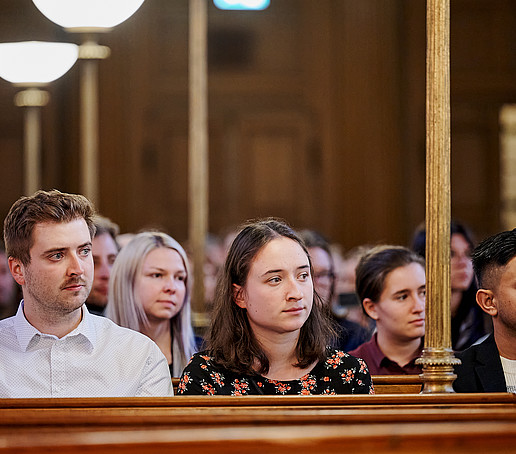 Guests in the rows of seats follow the program.