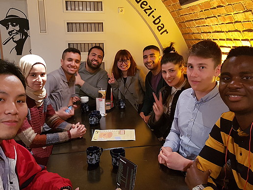 Group of students of different nationalities in a bar