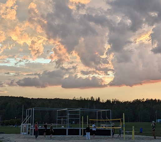 Volleyball is played on Lake Olbersdorf at dusk.