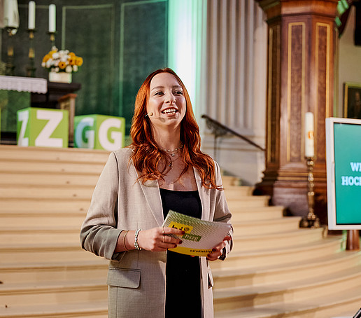 Presenter in front of the altar facing the audience