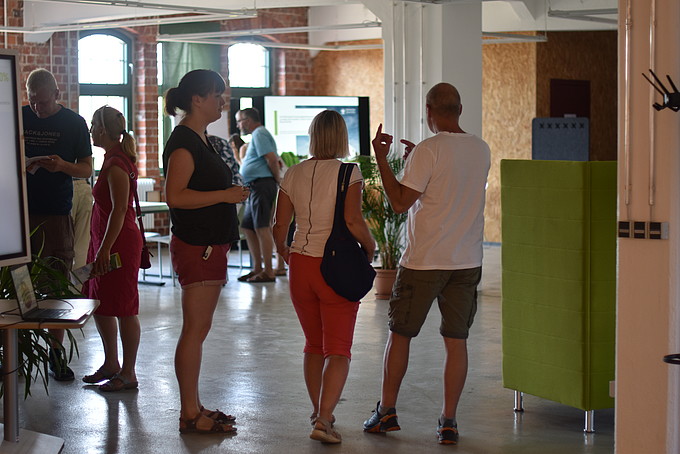 Visitors stand in the Celsiuz and have the premises explained to them.