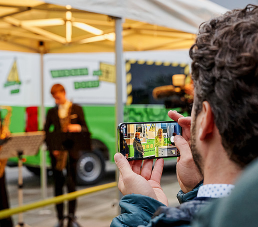 An employee takes a photo of the ZukLOS trailer.