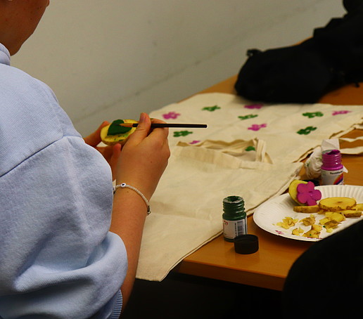 A person paints a potato stamp.