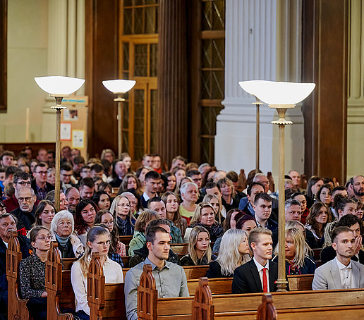 Guests in the rows of seats follow the program.