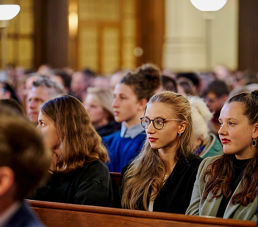 Guests in the rows of seats follow the program.