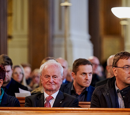 Guests in the rows of seats follow the program.