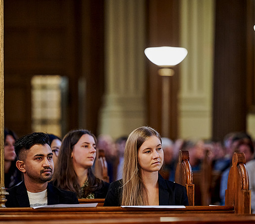 Guests in the rows of seats follow the program.