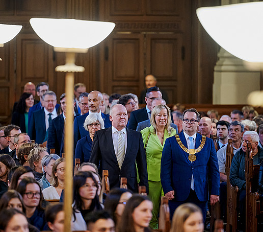 The Senate walks down the center aisle of the church towards the altar.