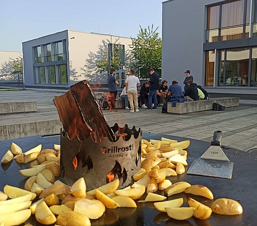 Potato wedges on a grill.