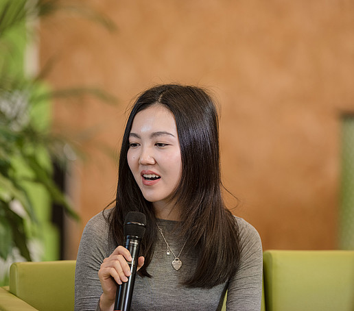 Kazakh student with microphone on the talk sofa